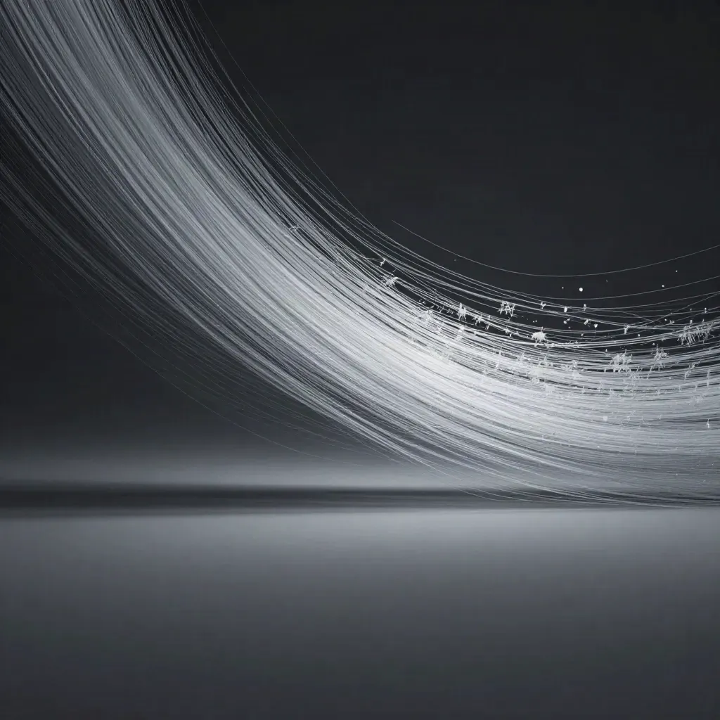 Silver filaments bloom in graphite haze with open space for headline text.